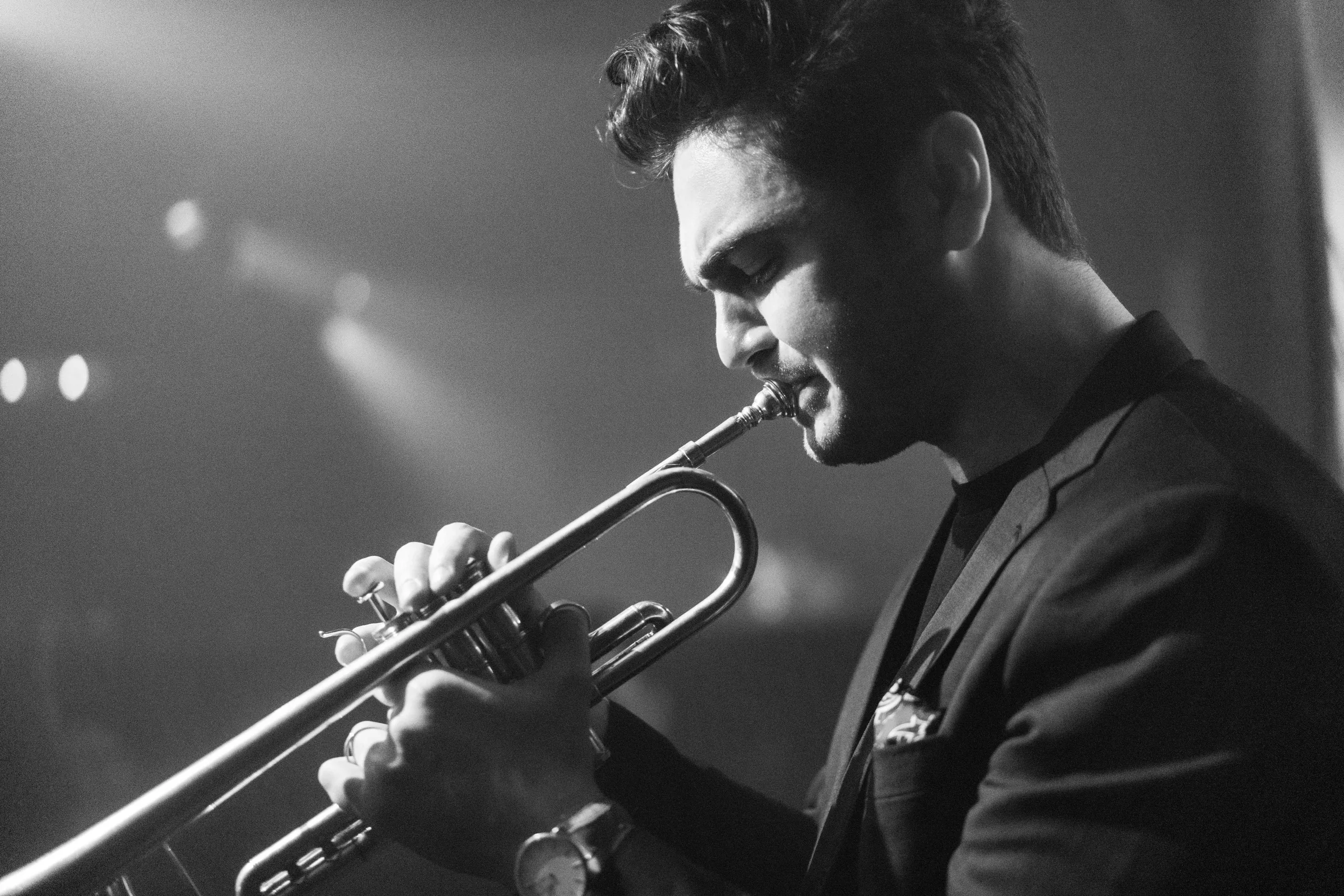 Man playing the trumpet in black-and-white